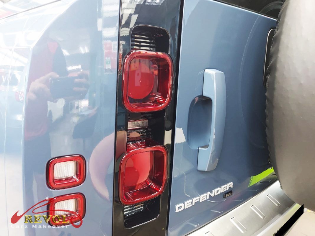 The coated bonnet of the Defender 110 under workshop lighting.