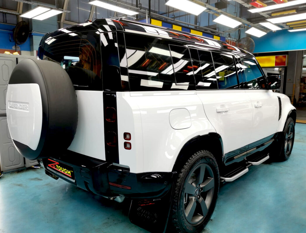 Rear quarter of the Defender, glossy and protected.