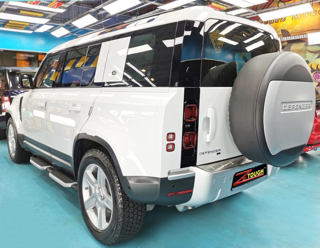 Rear quarter of the Defender, glossy and protected.