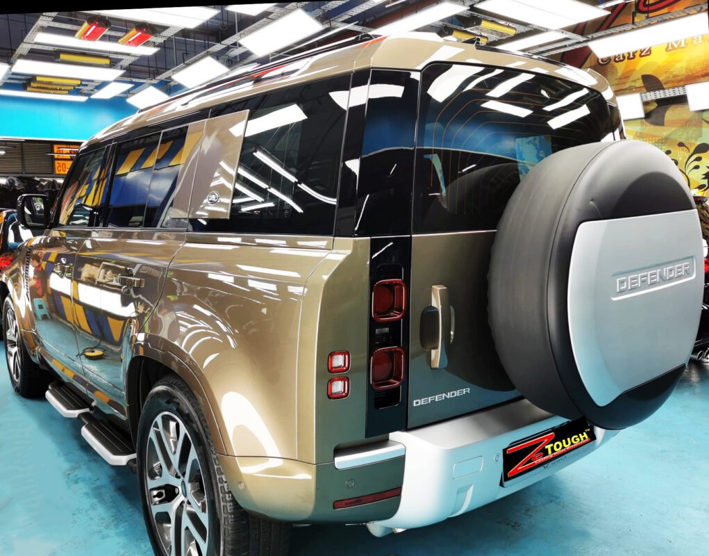 Rear quarter of the Land Rover Defender, glossy and protected.