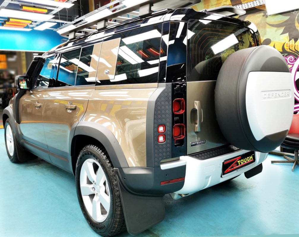Rear quarter of the Defender, glossy and protected.