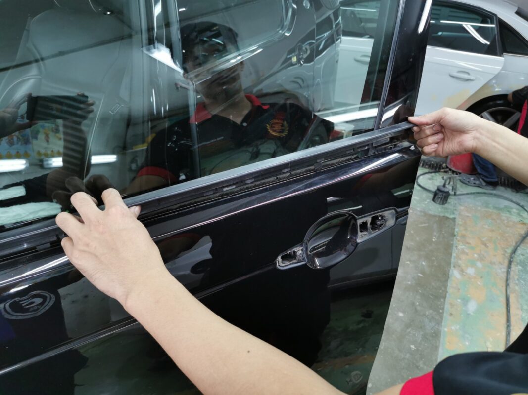 Surface of the Land Rover Discovery being examined and imperfections marked for repair.