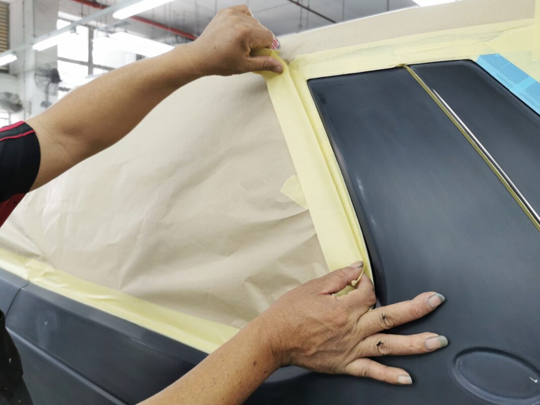 The Land Rover Discovery masked up, glass and trim covered before the spray booth.