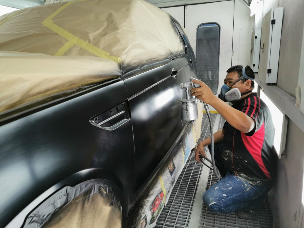 The Land Rover Discovery in the spray booth, fresh paint being applied.