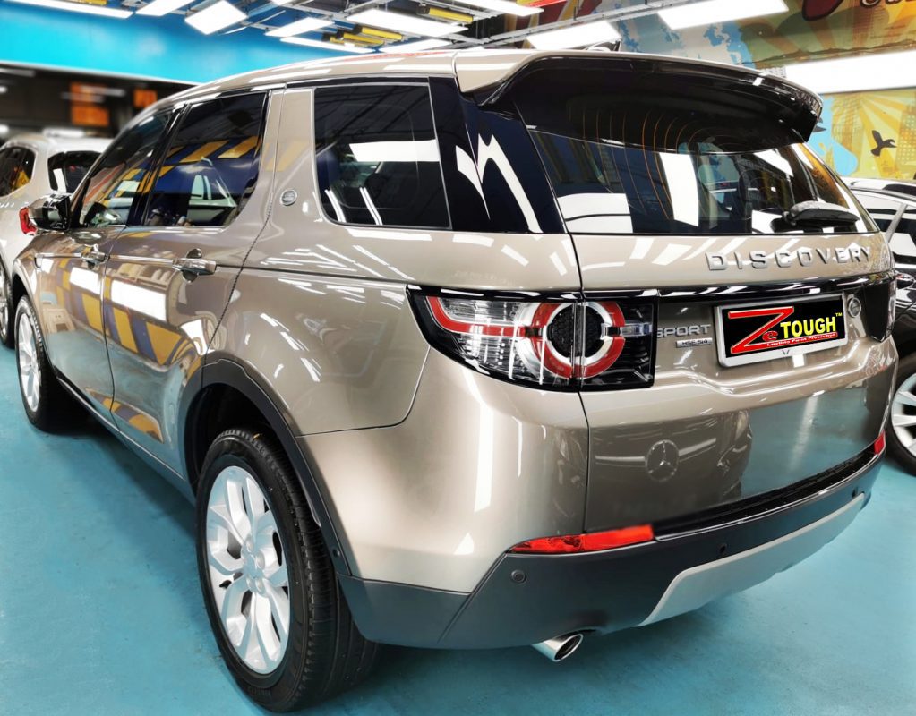 Rear quarter of the Discovery Sport, glossy and protected.