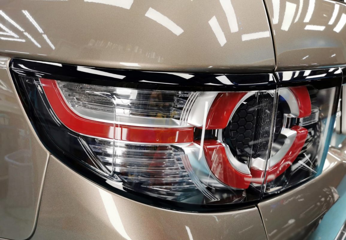 The coated bonnet of the Discovery Sport under workshop lighting.