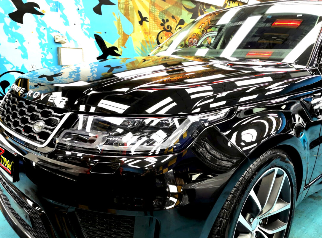 The Range Rover's coated paintwork under workshop lighting.