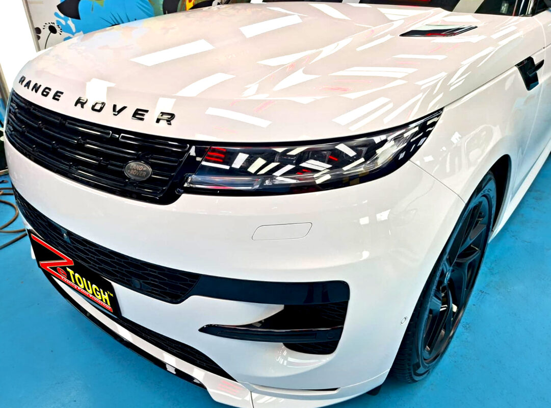 The Range Rover's coated paintwork under workshop lighting.