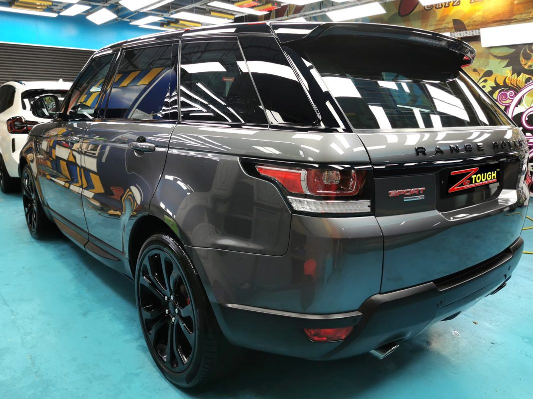 The coated bonnet of the Range Rover under workshop lighting.