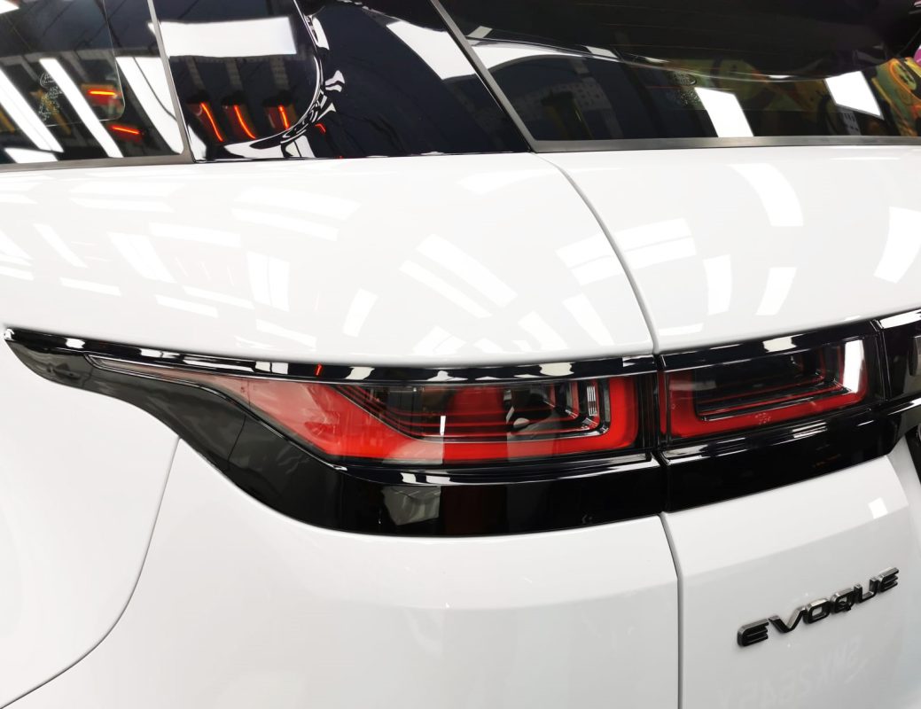 The coated bonnet of the Range Rover Evoque under workshop lighting.