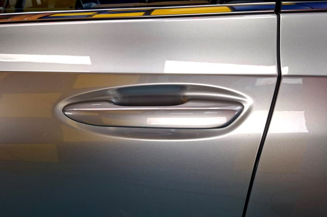 Door handle set into the champagne door panel of the ES 300h.