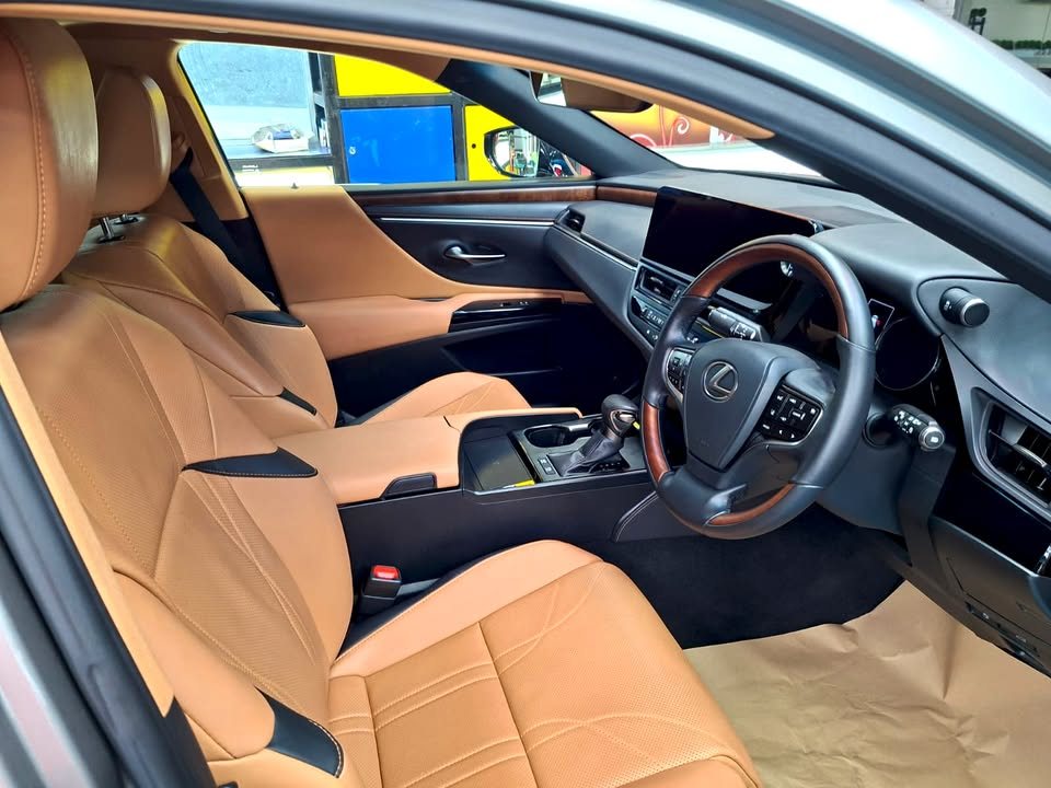 Tan leather front seats, steering wheel and dashboard inside the ES 300h.