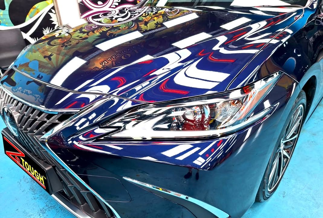 Close-up of the spindle grille and headlamp on the dark blue front end.