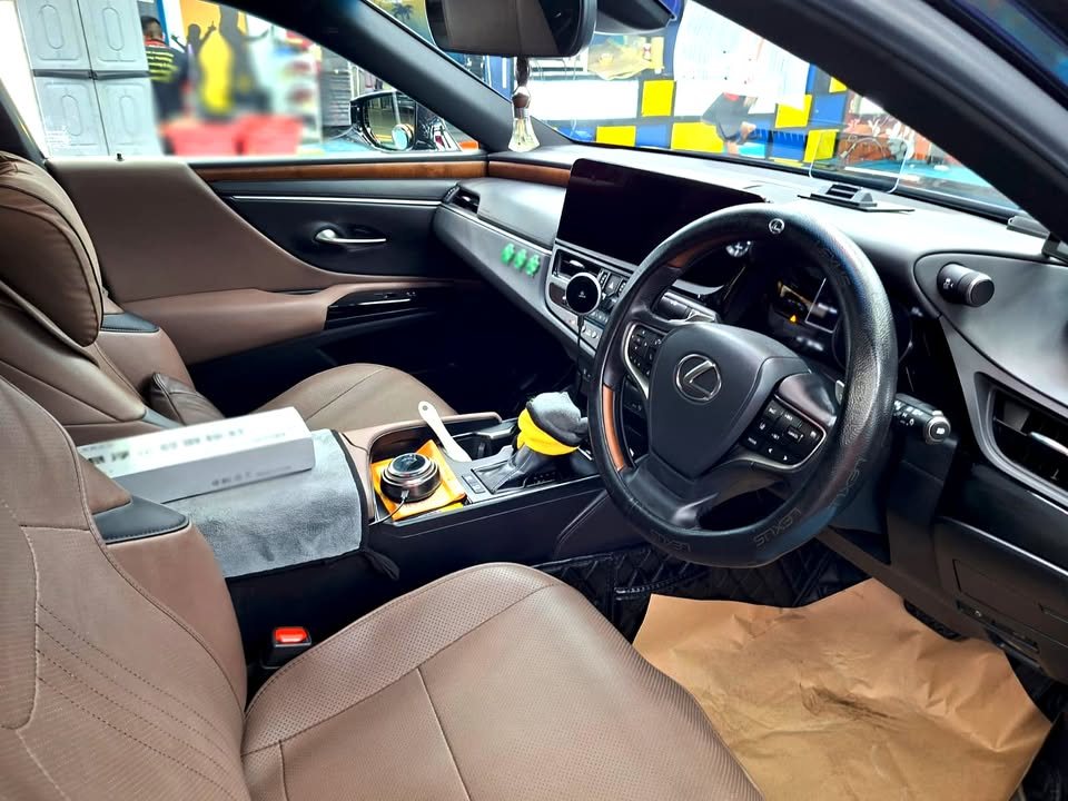 Interior view of the brown leather seats and steering wheel.