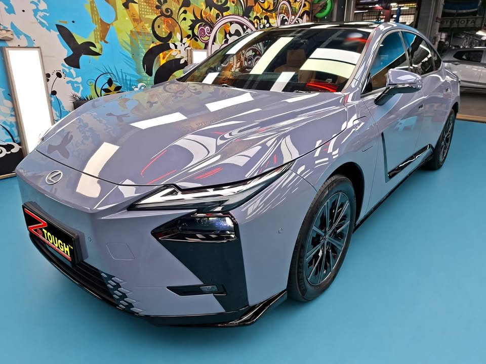 Blue grey Lexus ES 350e, front three-quarter view, in the Revol Carz workshop after coating.