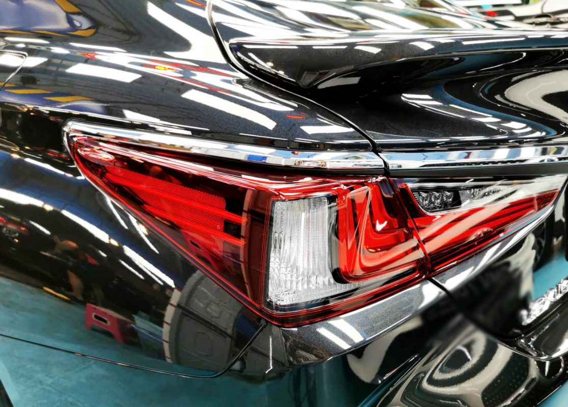 The coated bonnet of the Lexus ES300 under workshop lighting.