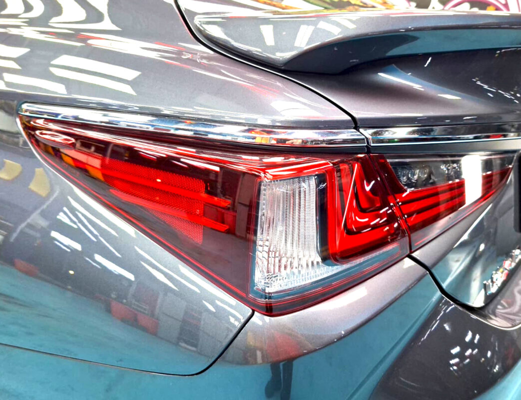 The coated bonnet of the Lexus ES300H under workshop lighting.