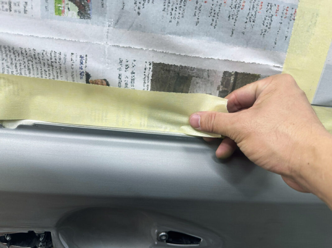 Non-painted surfaces being masked off on the Lexus ES300H.