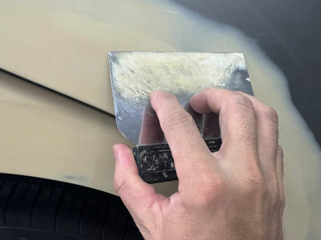 The Lexus ES300h body being inspected and dents patched before sanding.