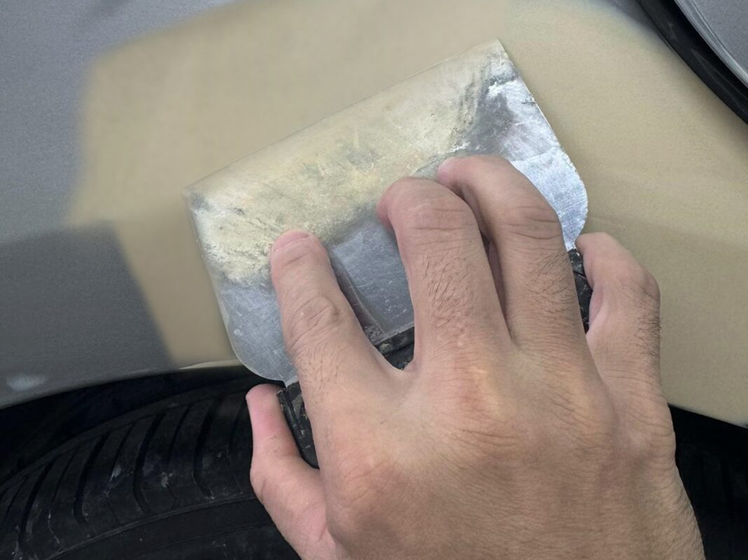 Body filler applied to a panel on the Lexus ES300h to level out imperfections.