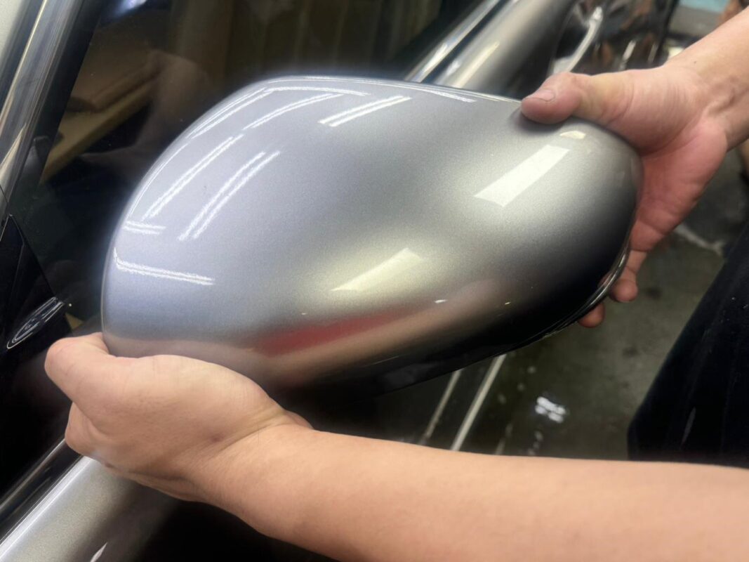 Machine-polishing the Lexus ES300h's panels to bring up the gloss after painting.