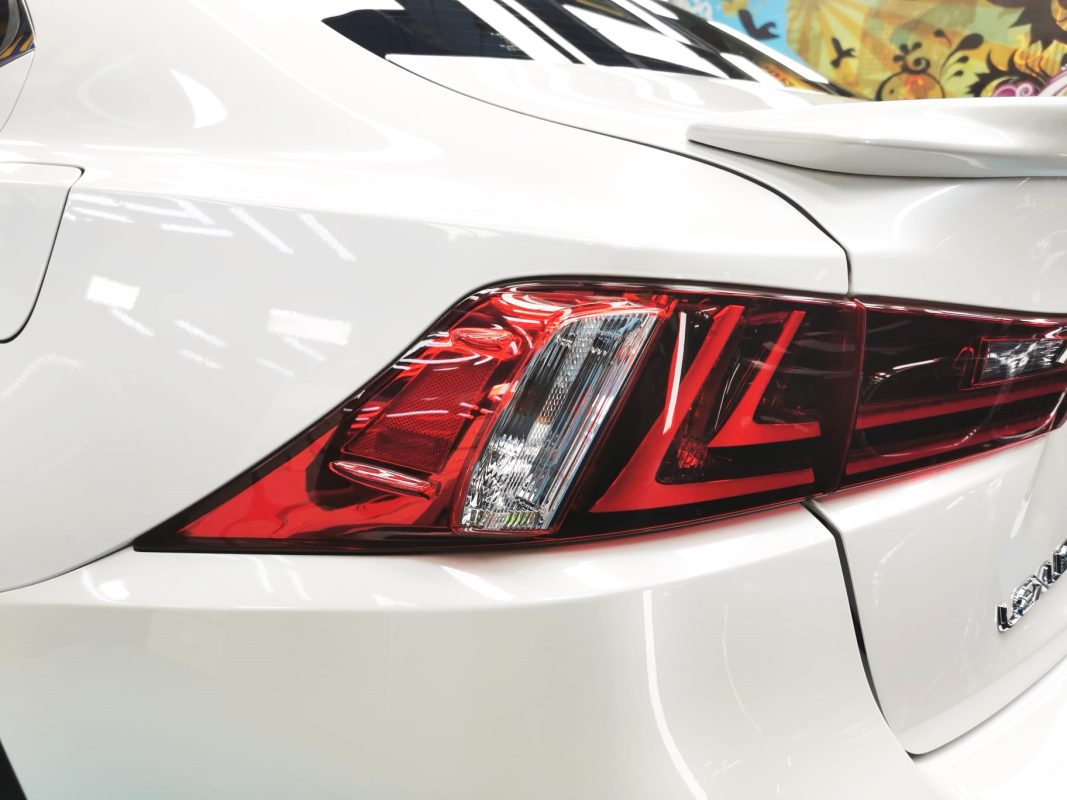 The coated bonnet of the Lexus IS200t under workshop lighting.