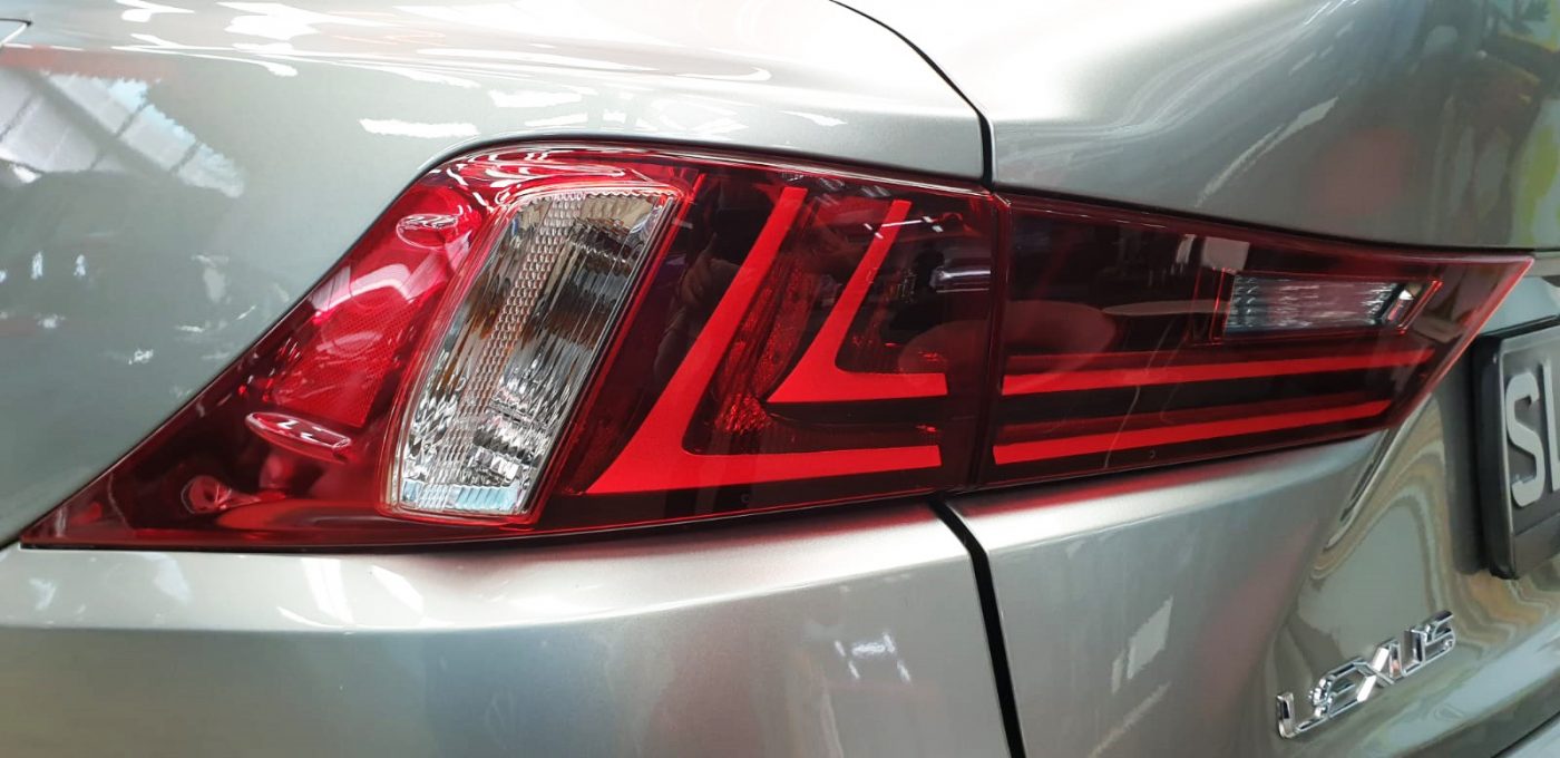 The coated bonnet of the Lexus IS200t under workshop lighting.