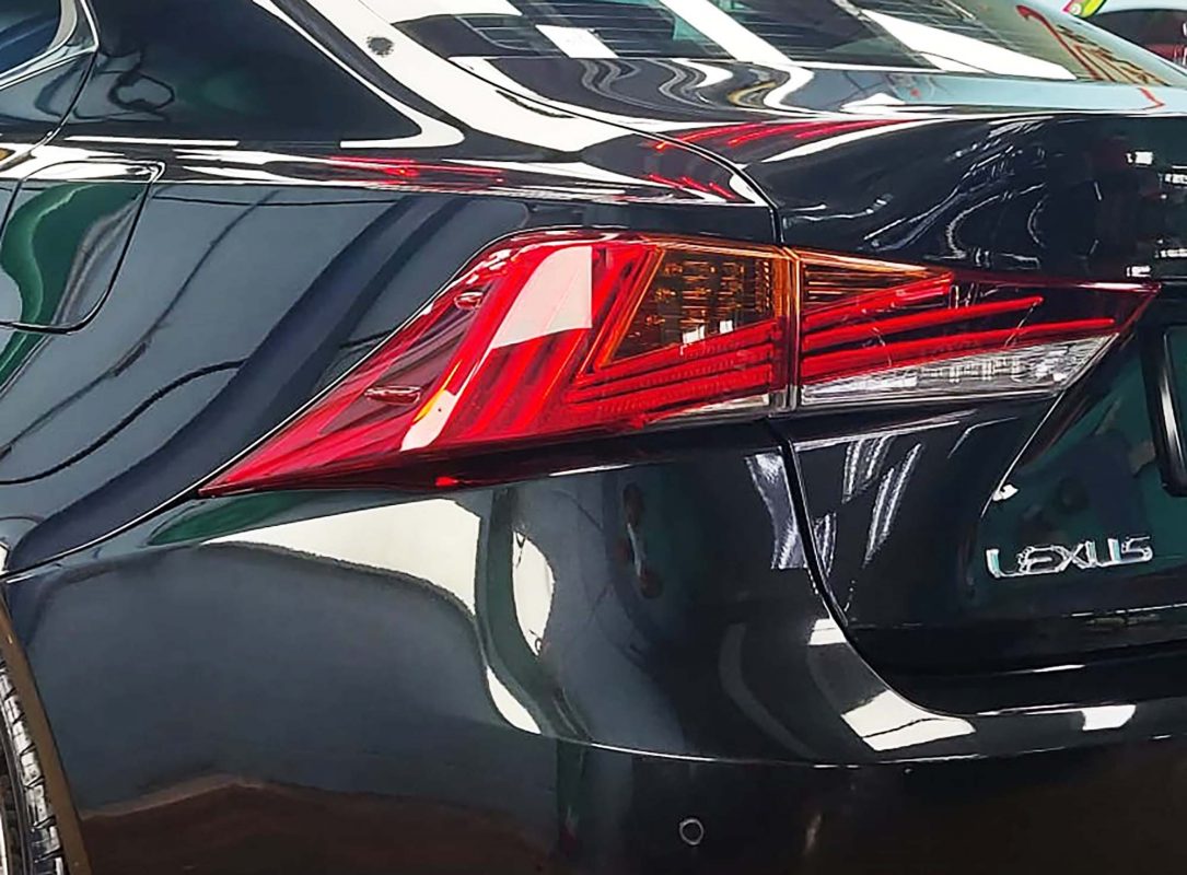 The coated bonnet of the Lexus IS300 under workshop lighting.