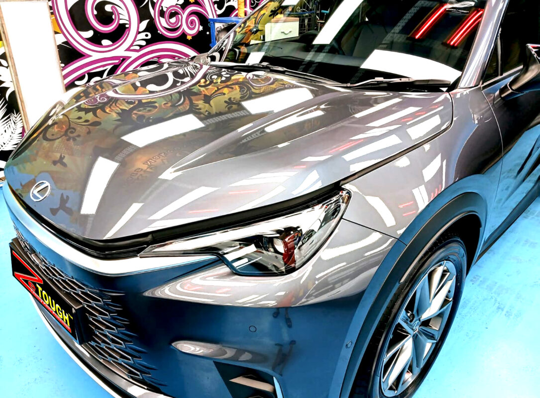 The Lexus LBX's coated paintwork under workshop lighting.