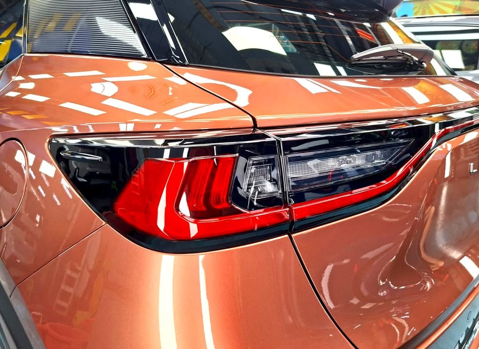 Close-up of the Lexus LBX tail lamp and copper rear quarter.