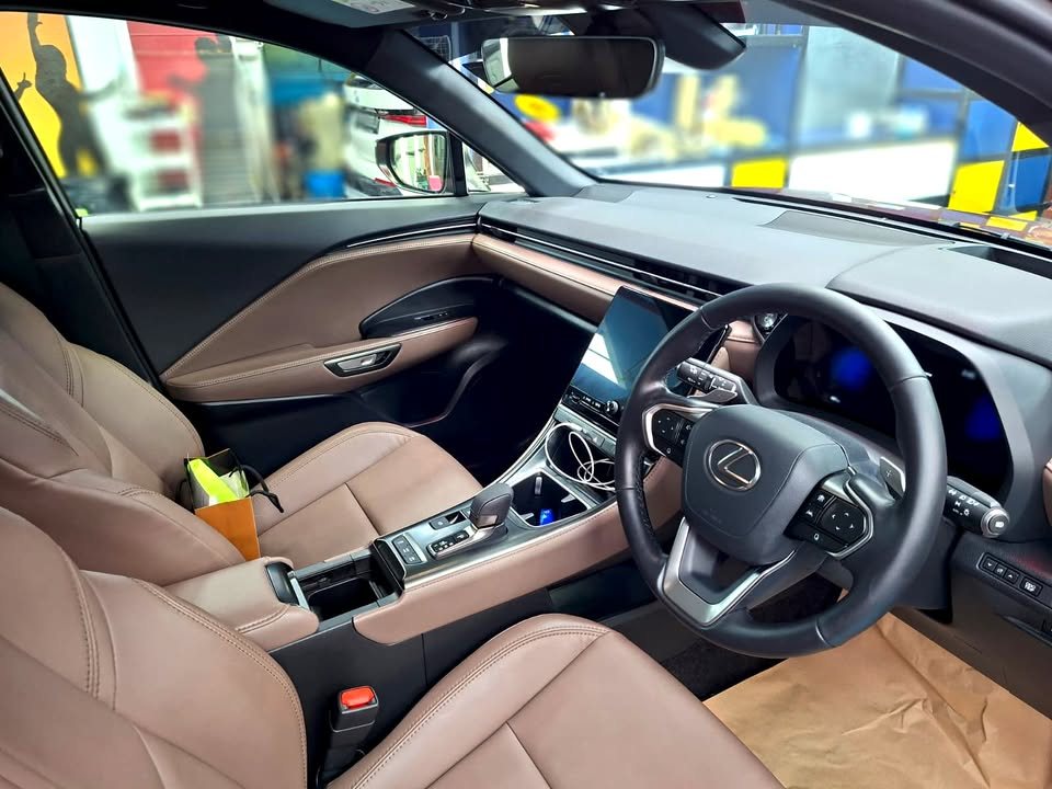 Lexus LBX cabin with brown leather seats and dashboard screen.