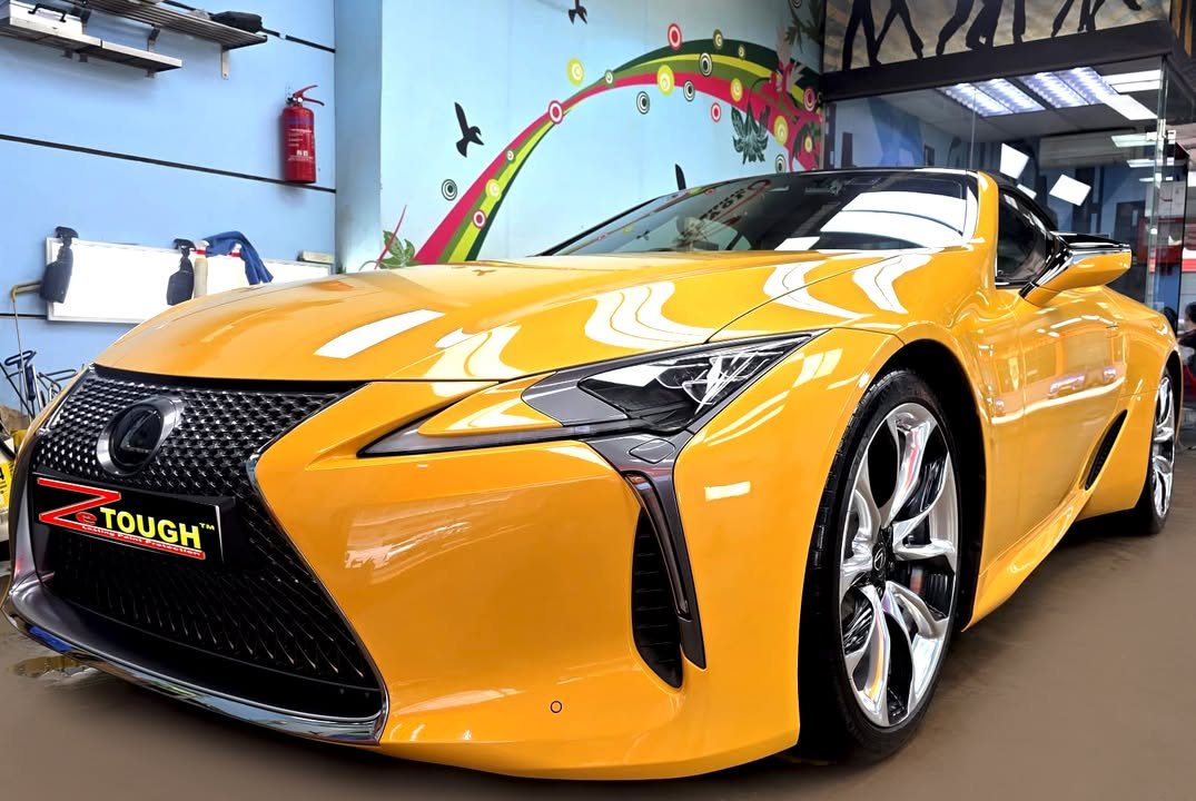 Yellow Lexus LC 500, front three-quarter view, in the Revol Carz Makeover workshop after grooming and ZeTough Ceramic coating.
