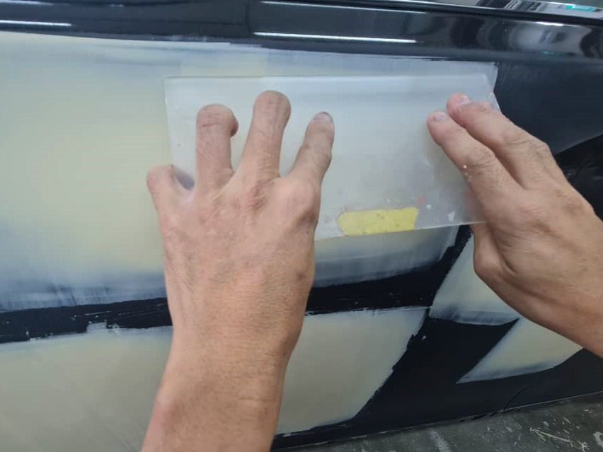 The LS 460's body being checked and patched for paintwork imperfections.