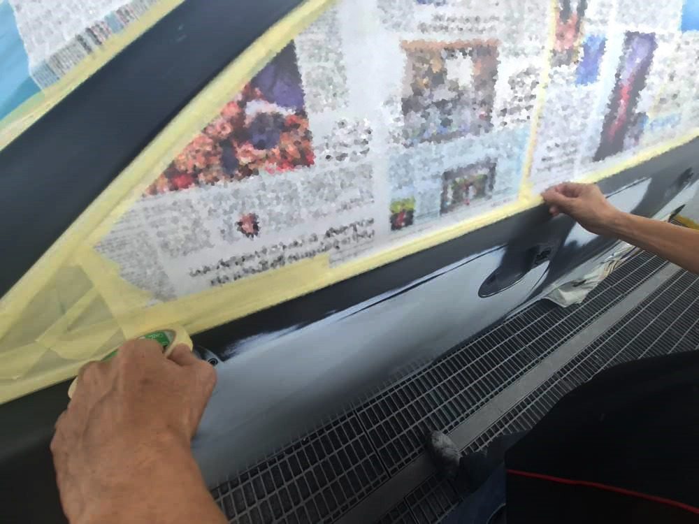 Non-painted surfaces being masked off on the LS 460 before spraying.