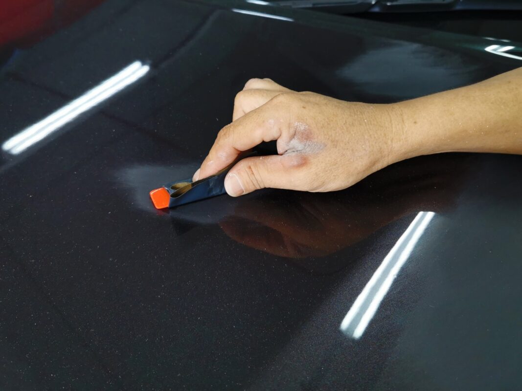 The LS 460 being wet-sanded again after spraying for an even surface.