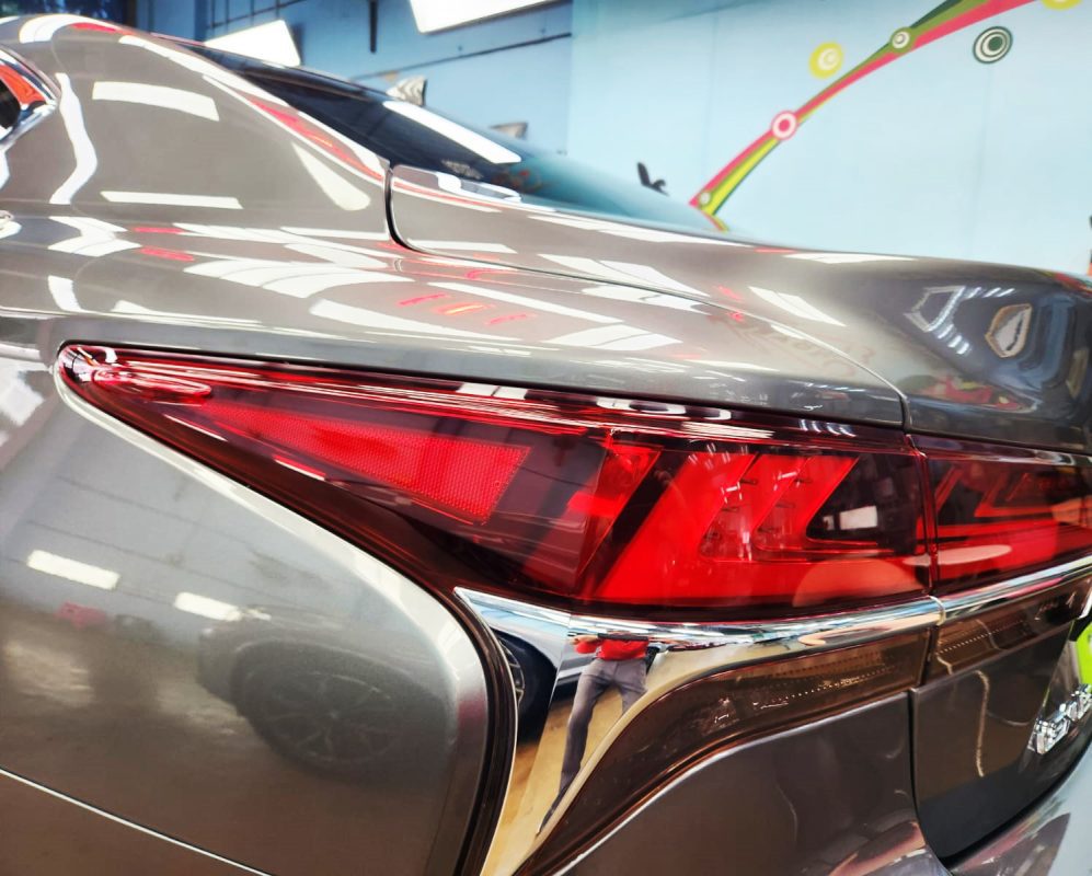 The coated bonnet of the Lexus LS350 under workshop lighting.