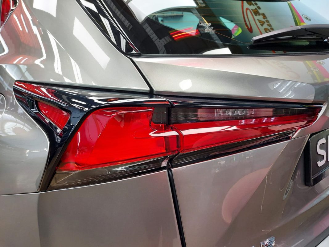The coated bonnet of the Lexus NX200 under workshop lighting.