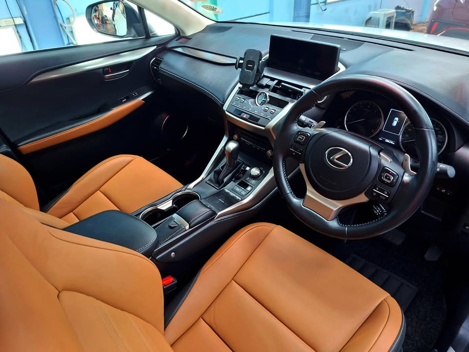 Lexus NX cabin with tan leather seats and a black dashboard.