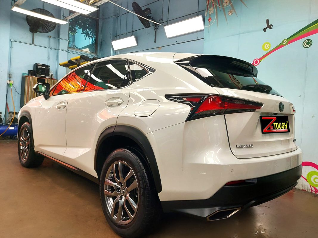 The coated bonnet of the Lexus NX200t under workshop lighting.