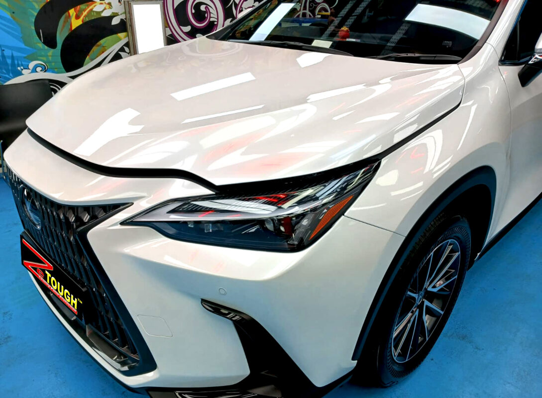 The Lexus NX350h's coated paintwork under workshop lighting.