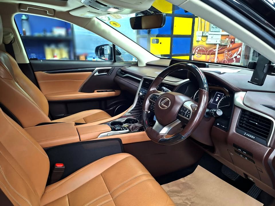 Lexus RX interior with tan leather seats and steering wheel.