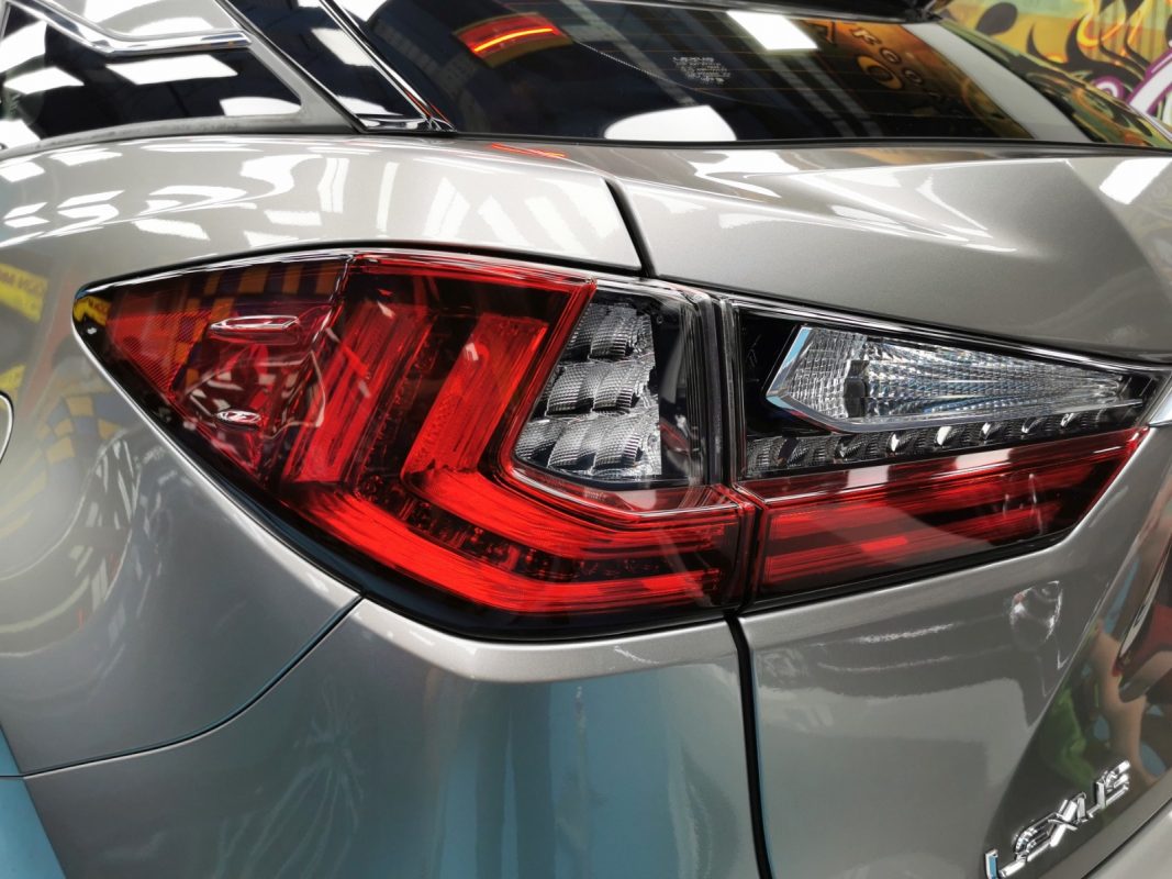 The coated bonnet of the Lexus RX200 under workshop lighting.
