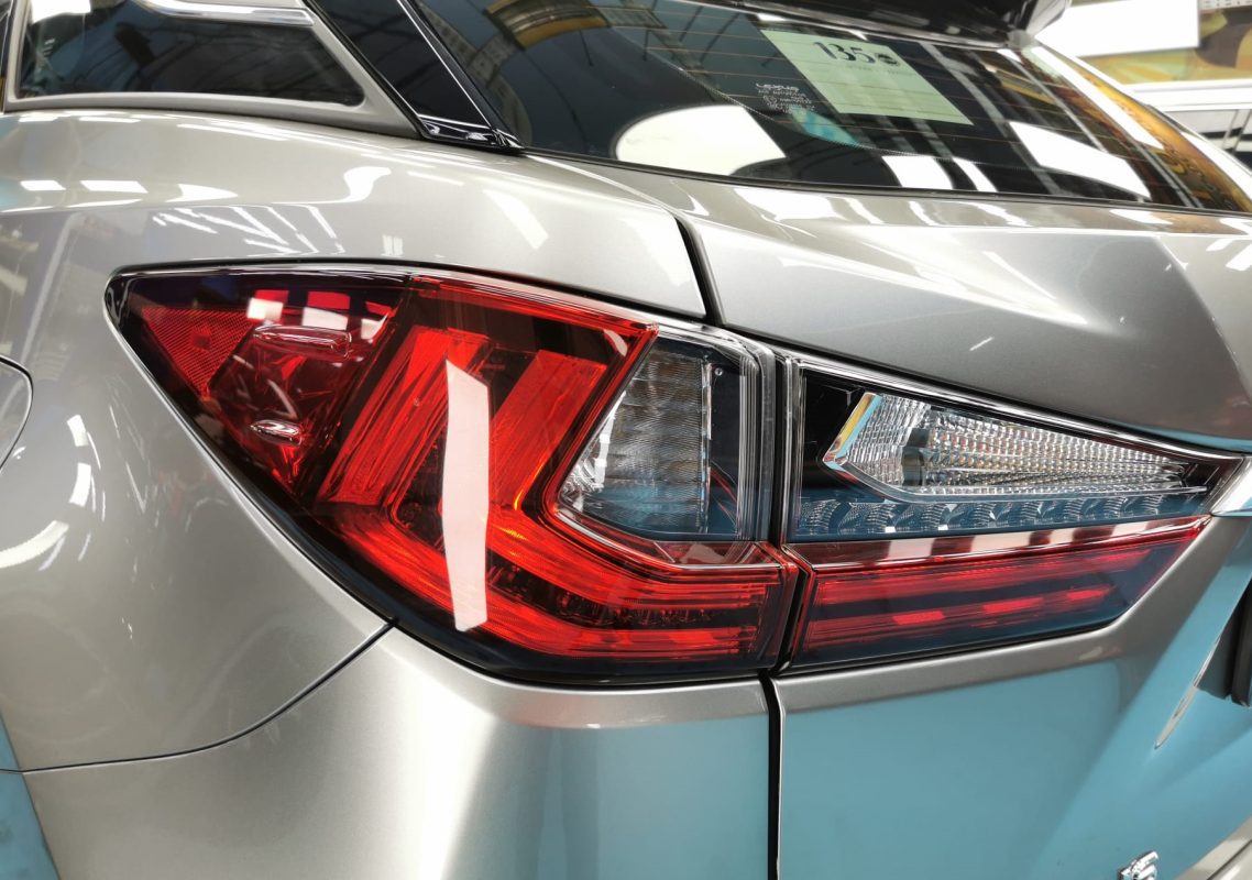 The coated bonnet of the Lexus RX200T under workshop lighting.