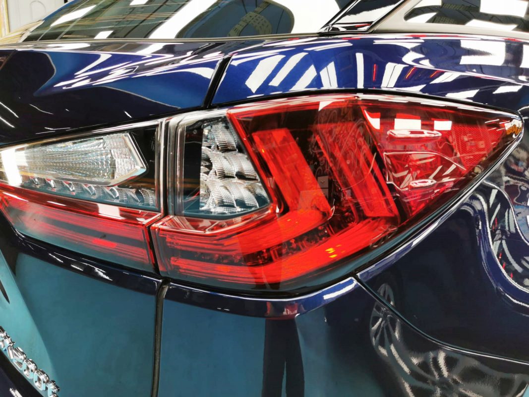 The coated bonnet of the Lexus RX200T under workshop lighting.