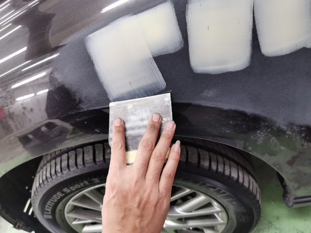 Chipped areas on the RX350 being patched before spraying.