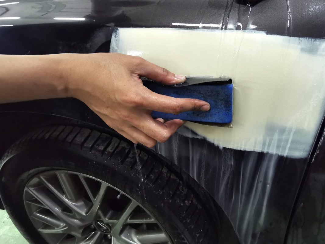 Wet-sanding the RX350's panels to smooth the existing paintwork.