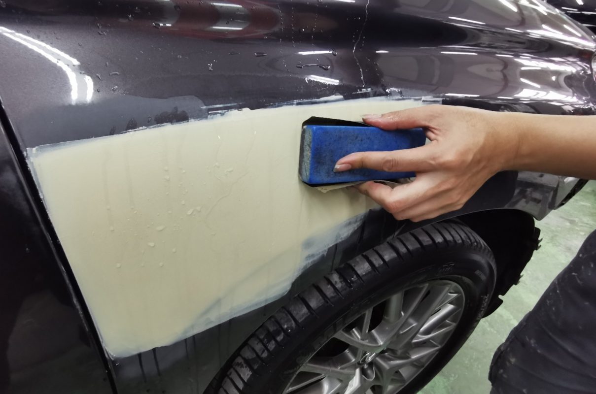 Continuing to wet-sand the body in preparation for spraying.