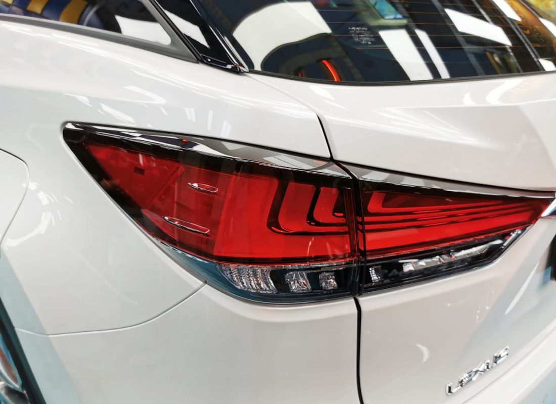 The coated bonnet of the Lexus RX350 under workshop lighting.