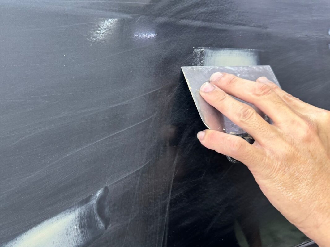 Bodywork repair in progress on the Lexus RX400h, patching chipped areas.
