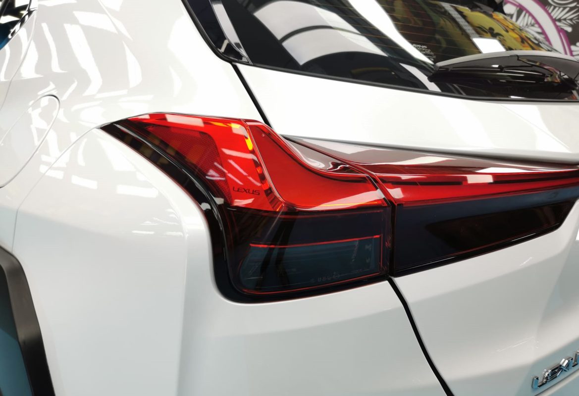 The coated bonnet of the Lexus UX250h under workshop lighting.